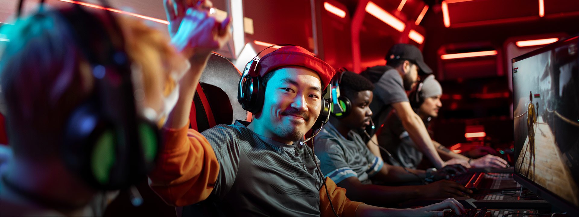 Pair of professional male gamers high fiving each other during a esport tournament