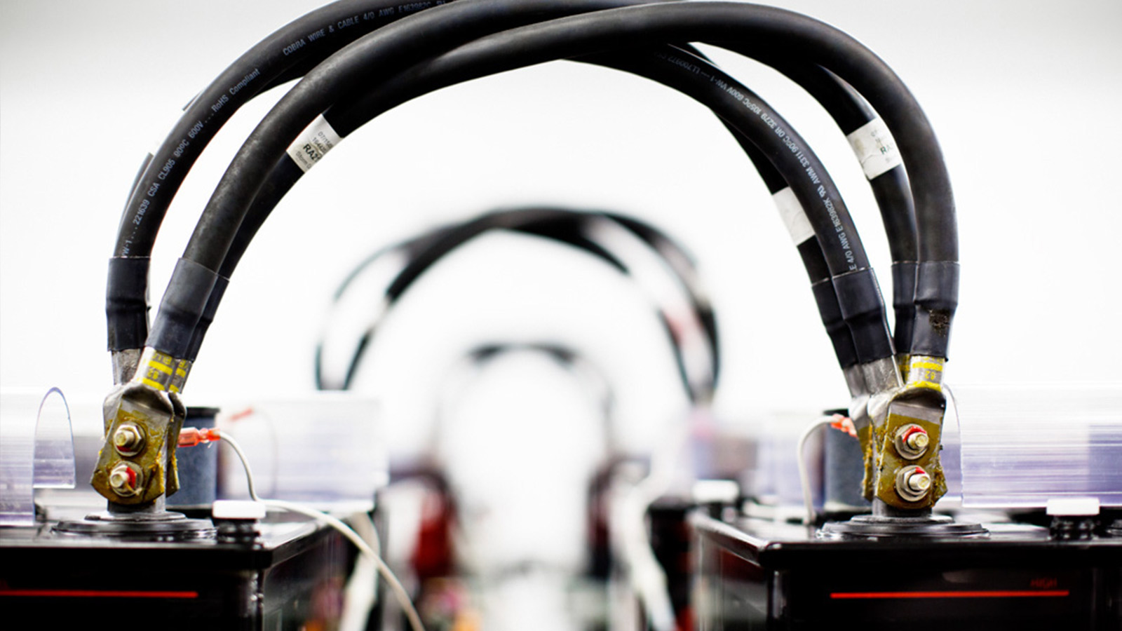 Rows of large batteries with every two connected by cables.