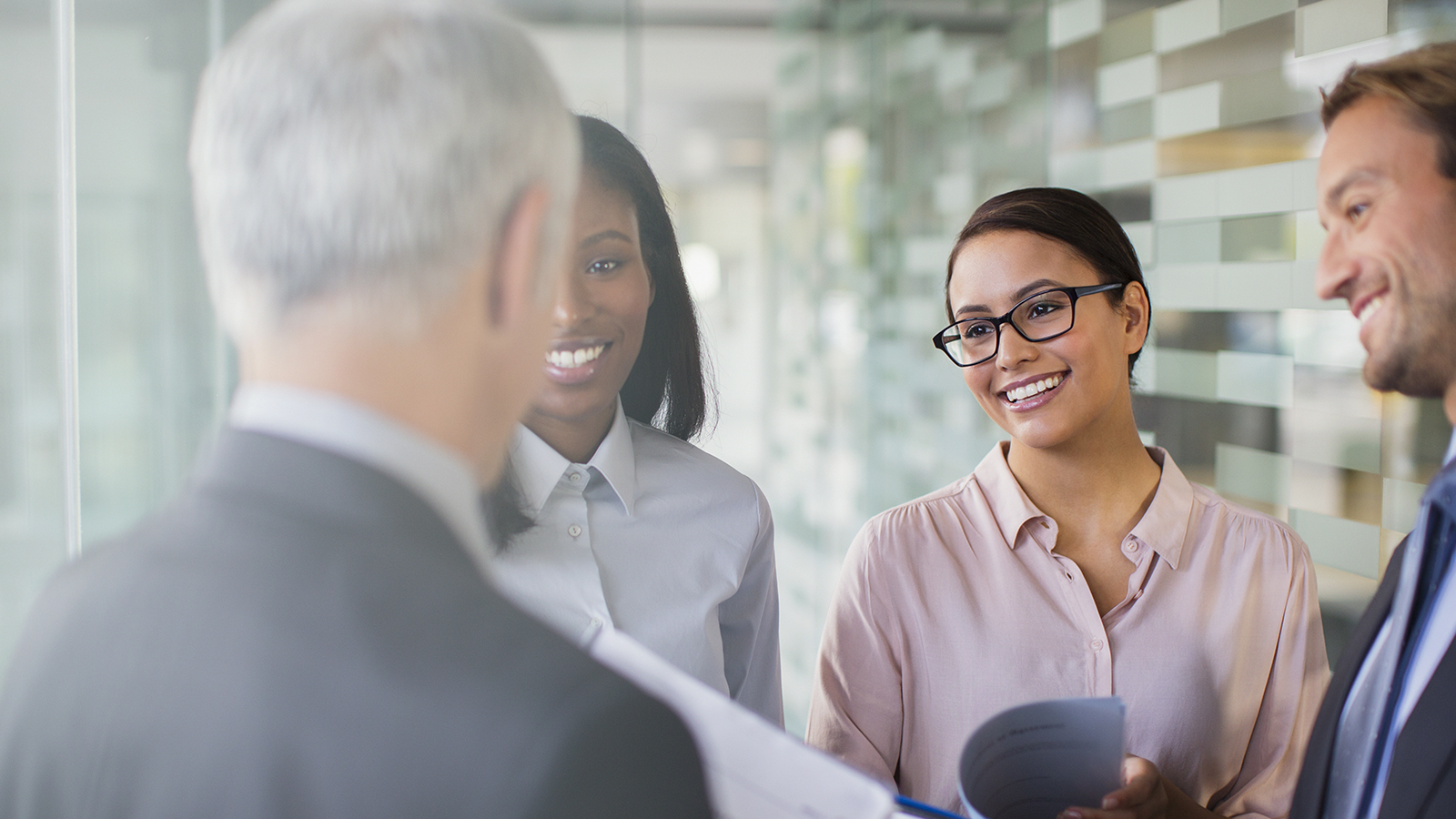 diverse group of smiling business people gathered in informal discussion