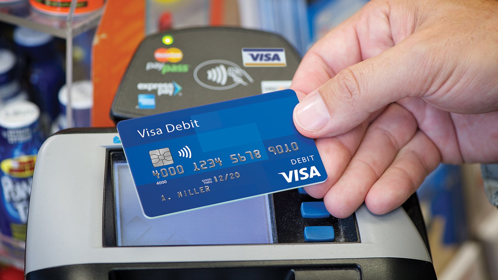 Presenting a contactless Visa debit card at checkout. Presenting a contactless Visa debit card at checkout.