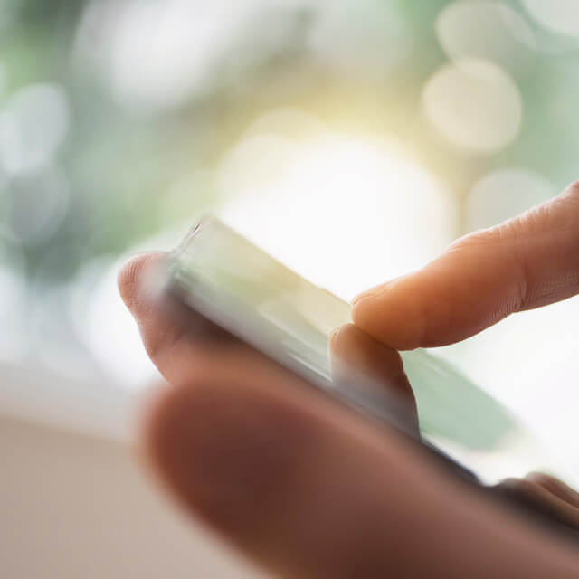 Man holding a phone and a credit card