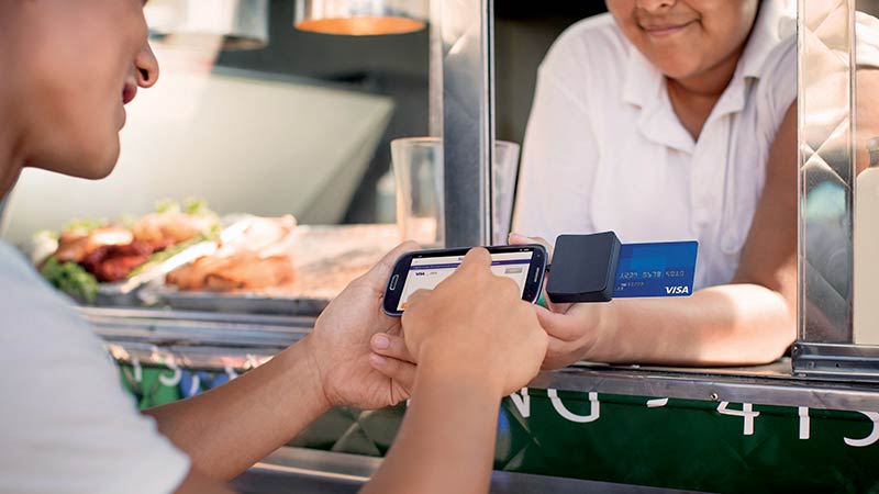 risk-fraud-consumer-transaction-800x450 Customer completing a transaction using a mobile credit card reader at a food truck.