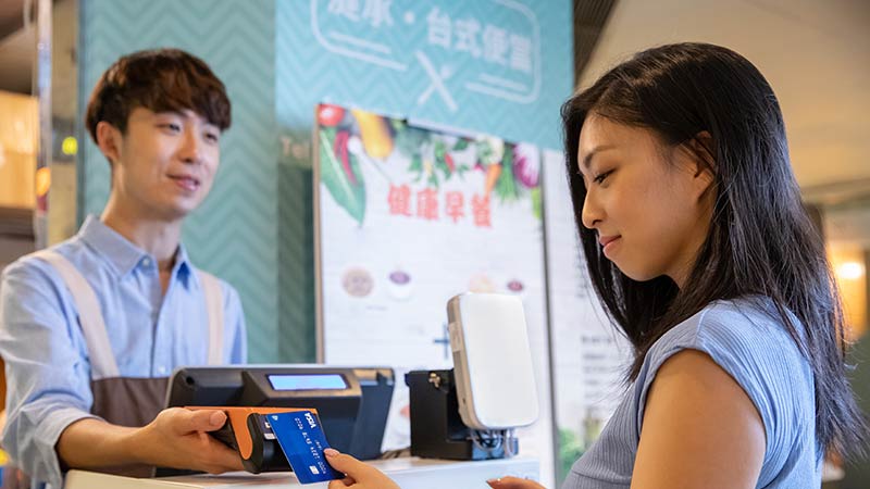 lady tapping credit card in a tea shop