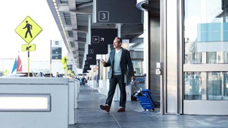 man walking out of airport