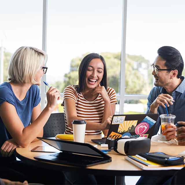 three person having a good time working